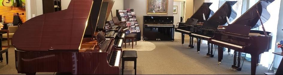 Peabody's Piano Co. showroom — multiple grand pianos