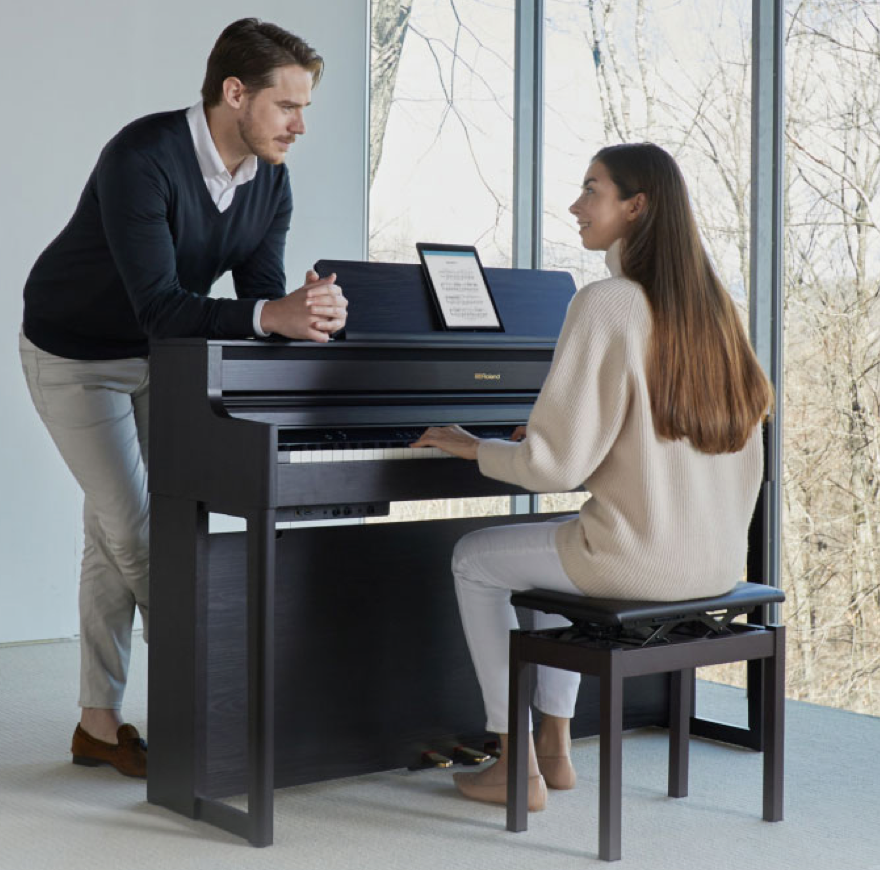 Piano lesson with teacher and student